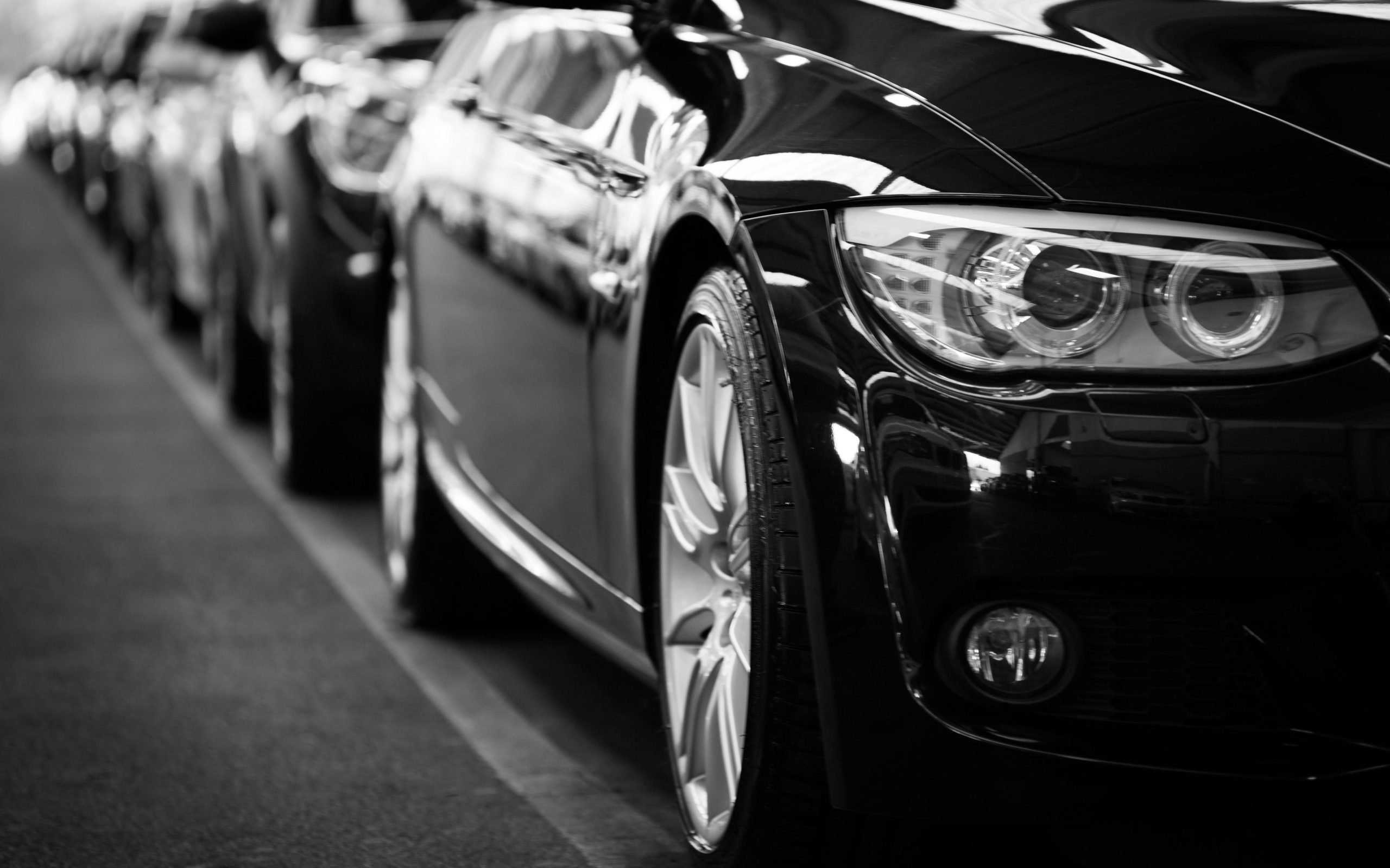 A convoy of black cars in motion. PHOTO/Pexels