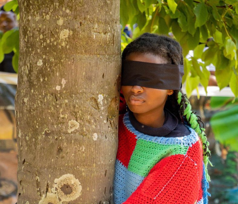 Truphena Muthoni hugging a tree with her eyes blindfolded. PHOTO/https://www.facebook.com/truphena.dmuthoni