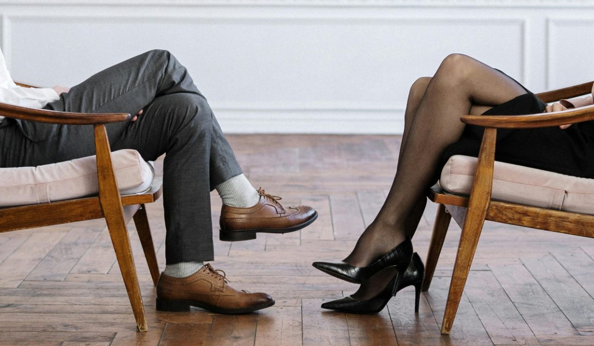 A man and a woman sitting. 