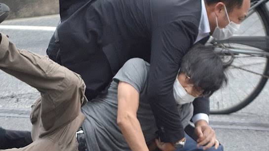 Security detail arrest a man after former Japan PM shooting. PHOTO/@JasADRxquisites/X