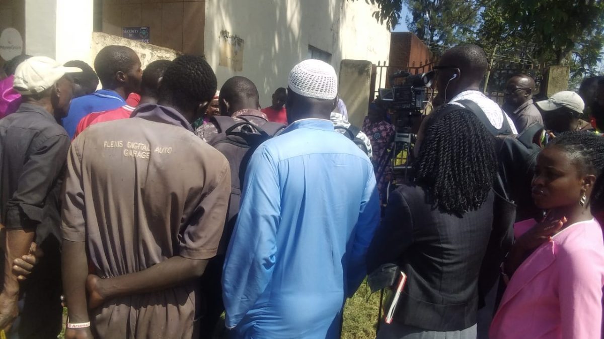 Grief stricken locals mill around the scene where two bodies of a man and woman were found dumped in septic tank at Mbale town in Vihiga county.