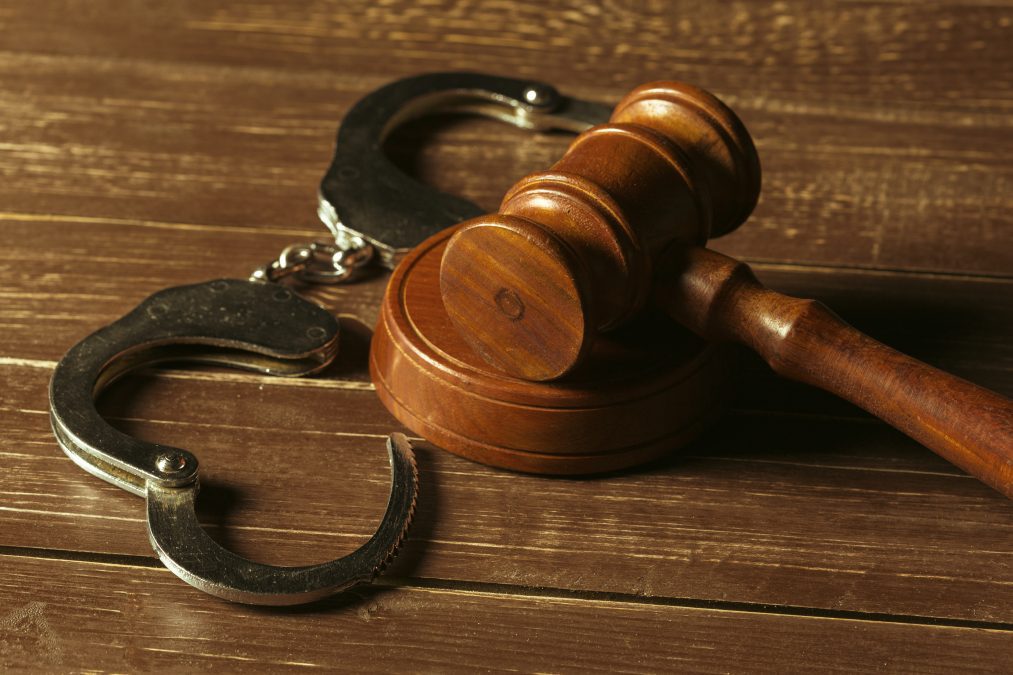 Gavel placed ontop of handcuff. PHOTO/Pexels