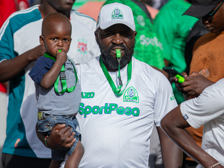 An adult Gor Mahia fan with a young one during a football match previously. PHOTO/@OfficialGMFC/X