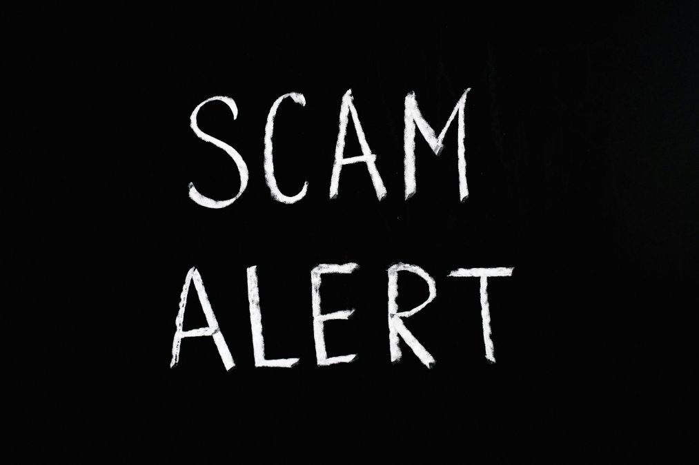 Scam alert text on a black background. Image used for illustration purposes. PHOTO/Pexels