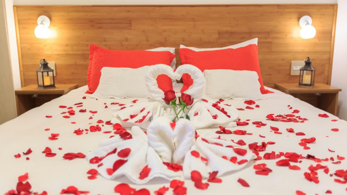 A photo of a bed sprayed with red flowers. PHOTO/Pexels