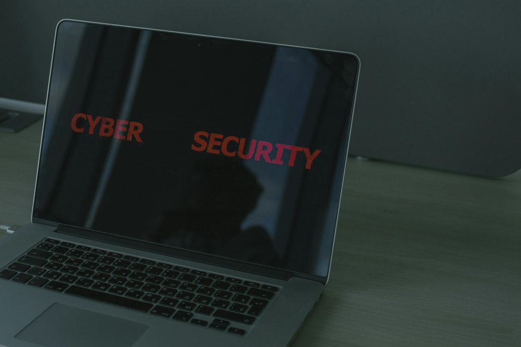 A laptop sits on a desk with the words “CYBER SECURITY” displayed on its screen. PHOTO/Pexels