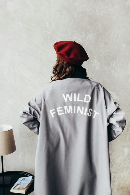 Someone wearing jacket written wild feminism. PHOTO/Pexels