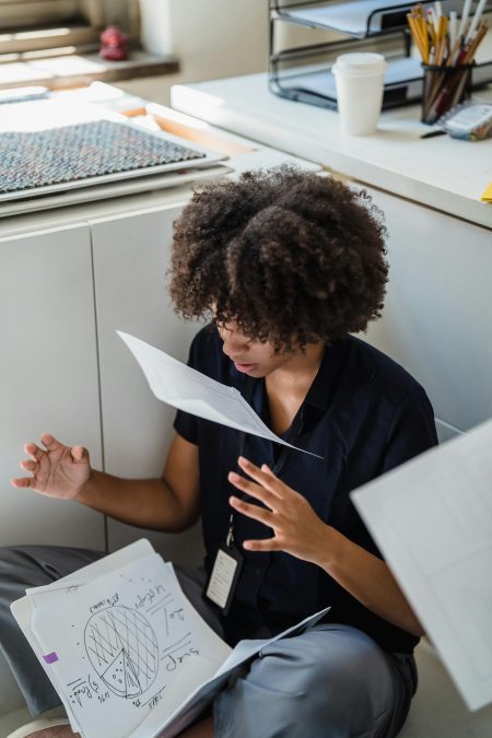 Woman throwing documents into the air. Image used for illustration purposes. PHOTO/Pexels
