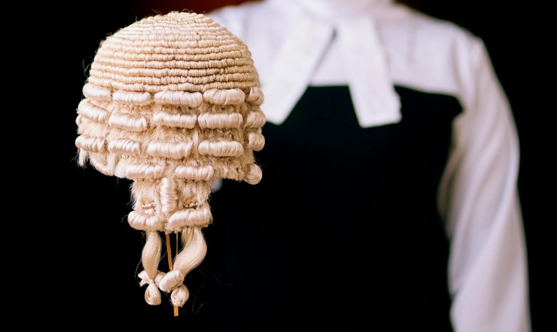 Some holding a judicial wig. PHOTO/Pexels