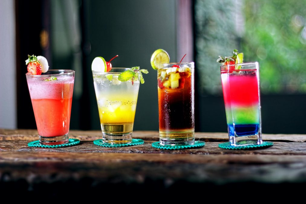 Four cocktail glasses on brown wooden surface. Image used for illustration purposes. PHOTO/Pexels