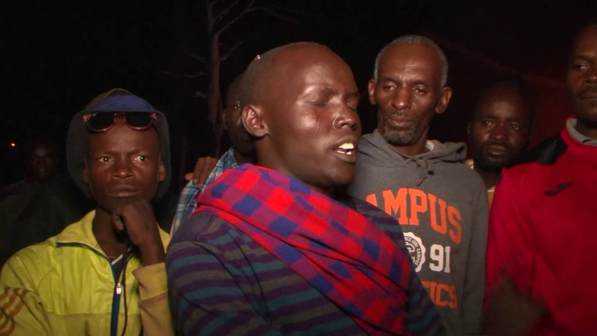 Elijah Shongo, one of the watchmen guarding the premises speaks to journalists at the fire scene. PHOTO/Olive Musembi