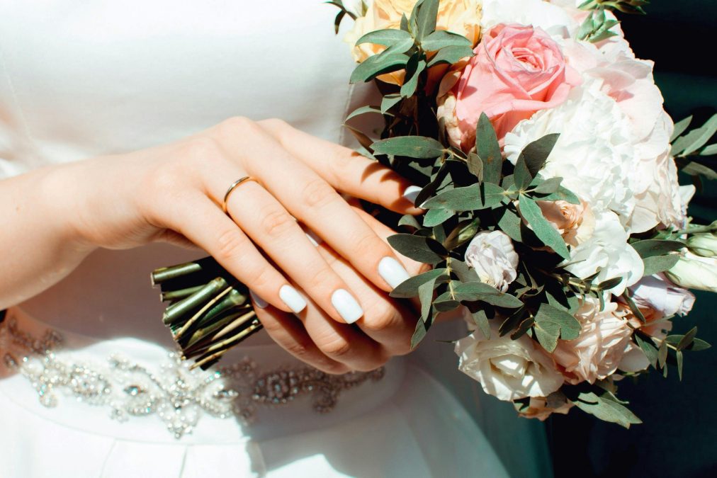 A lady holding flowers shortly after marriage. Image used for illustration purposes. PHOTO/Pexels