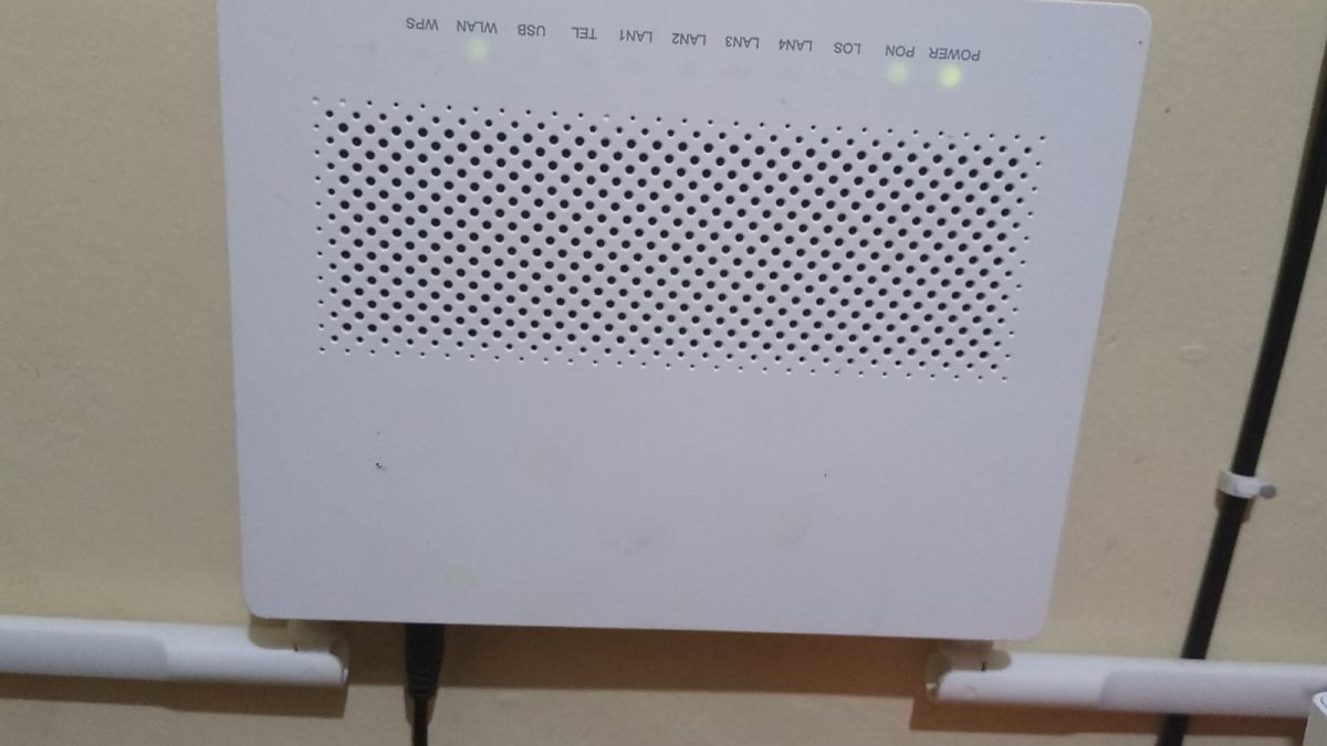 A WiFi router mounted on a wall with indicator lights showing power and network activity, a device that distributes wireless internet signals to connected devices inside a house. PHOTO/David Nthua