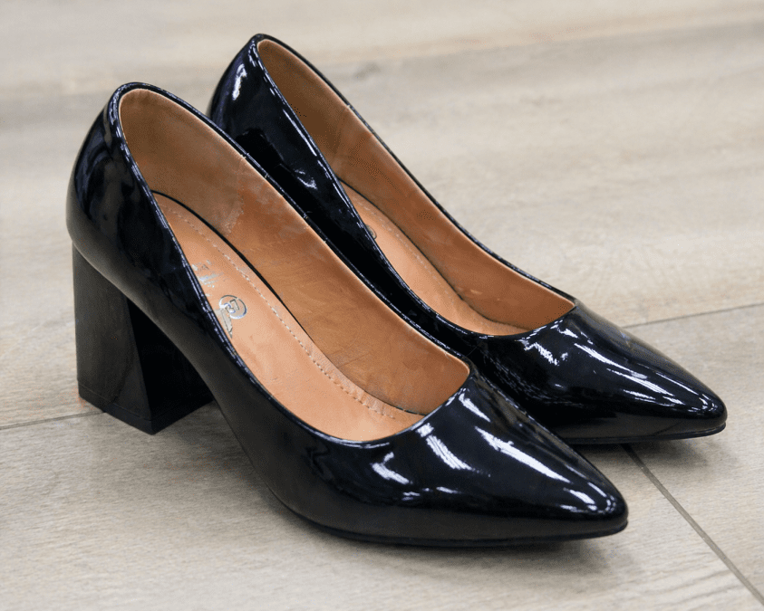 Close-up image of glossy black women’s high heel shoes with hard soles, ideal for illustrating loud footwear. PHOTO/Photo generated by AI