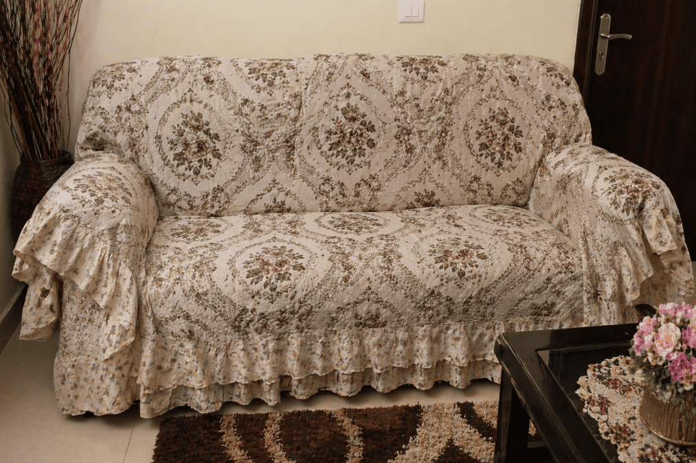 Living room sofa covered with an old-fashioned patterned fabric cover. PHOTO/Photo generated by AI