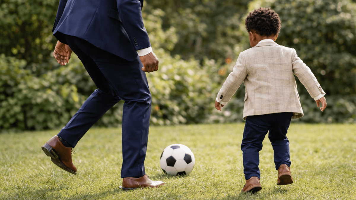 A man playing football with a boy. PHOTO/Photo generated by AI