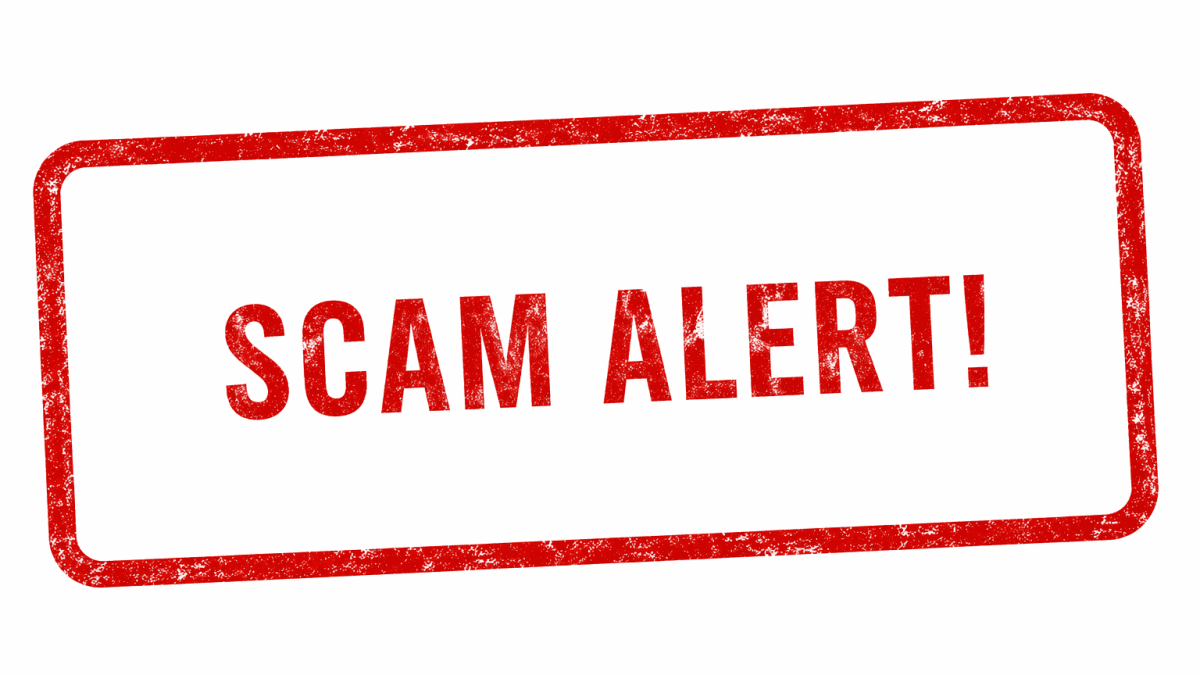 Red Scam Alert text inside a distressed warning stamp frame on a clean white background landscape banner. PHOTO/Photo generated by AI