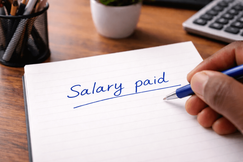 A piece of paper with words Salary paid, written. PHOTO/Photo generated by AI