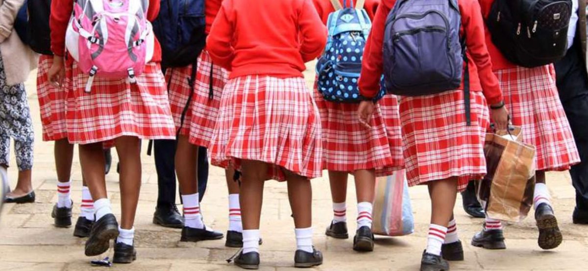 Secondary school students carrying bags wait at a stage to travel back to school. PHOTO/Photo generated by AI