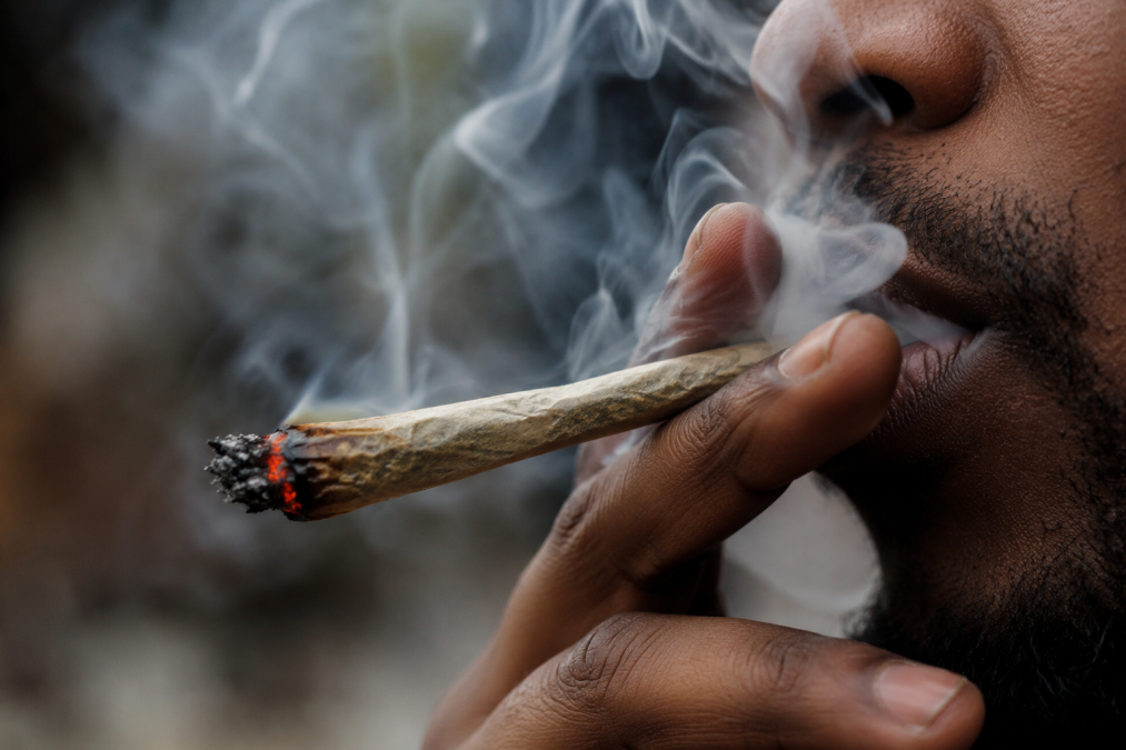 Close up image of a man smoking a rolled bhang. PHOTO/Photo generated by AI
