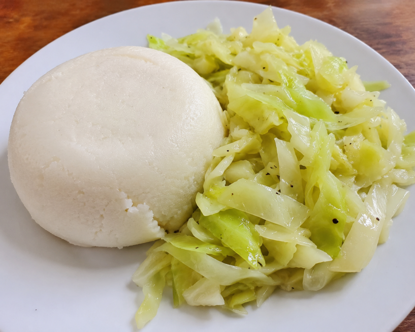A plate of ugali with boiled cabbage