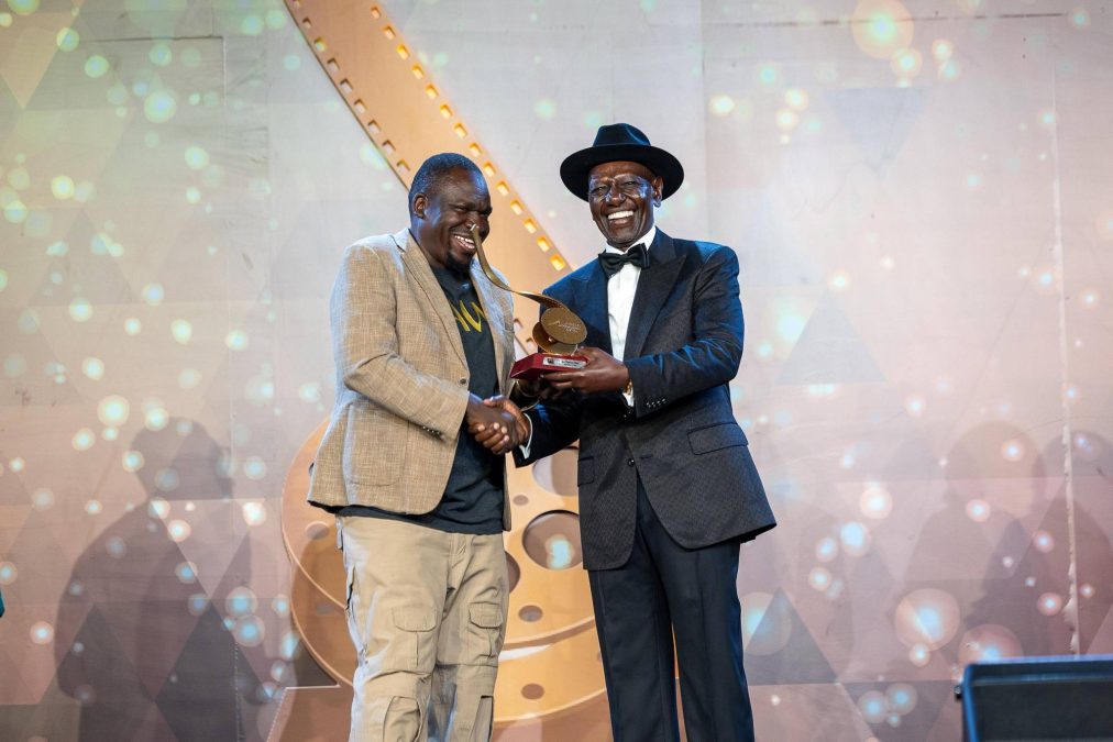 Brizan Were receives his award for Best Feature Film from President William Ruto. PHOTO/https://web.facebook.com/williamsamoei