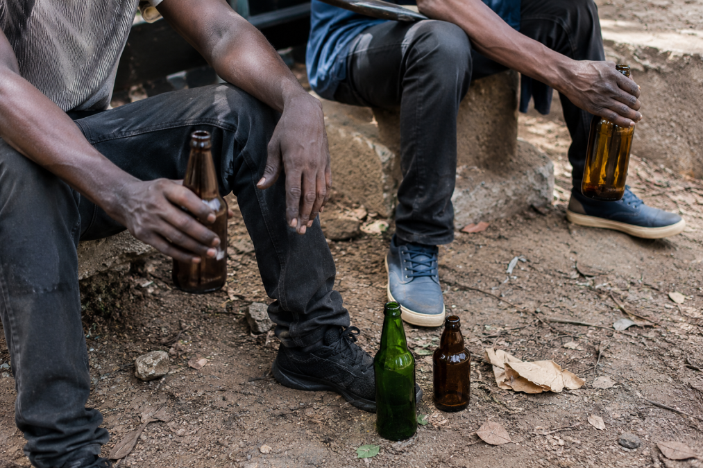 Black men holding alcohol bottles. PHOTO/Photo generated by AI