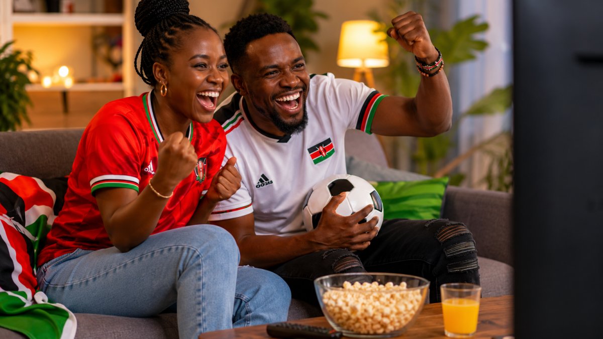 A young couple celebrates a crucial World Cup moment together from their living room sofa. PHOTO/ChatGPT