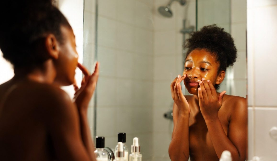 A girl doing her skin care routine.