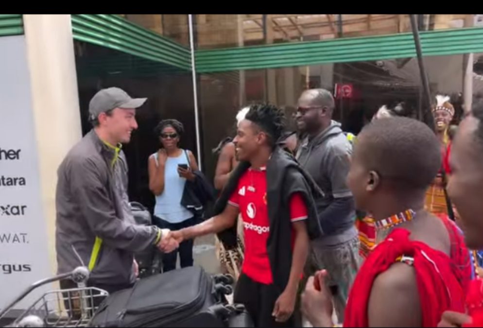 Eric Omondi receiving Manchester United fans’ coach at JKIA. PHOTO/screengrab by K24 Digital from video posted by @trudykitui/Instagram