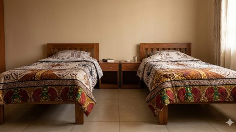 Two neatly made separate single beds with patterned bedding. PHOTO/Gemini