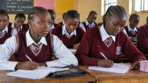 Girls sitted inside a classroom.