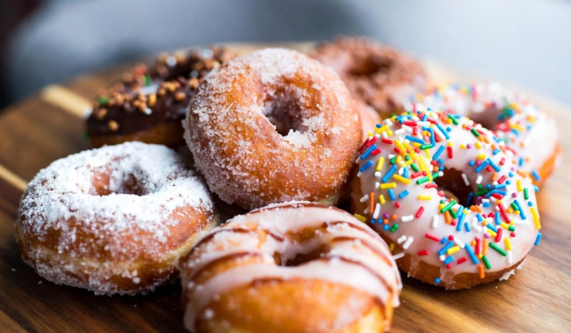 Sugary donuts on a plate.
