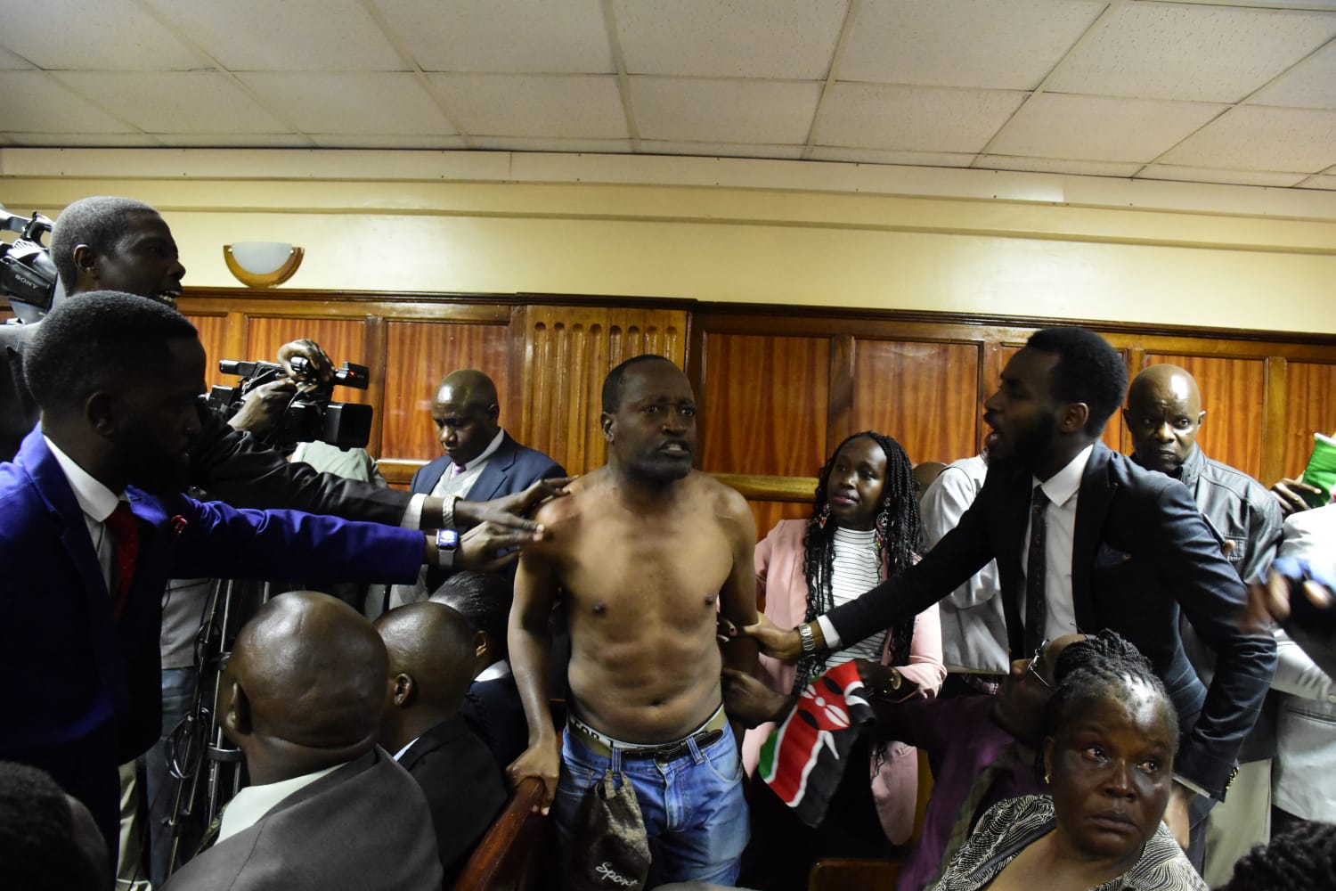 Activist removes shirt, disrupts court proceedings over 3 missing Kenyans