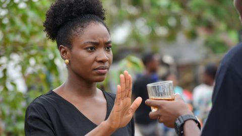 An African woman saying no to alcohol.
