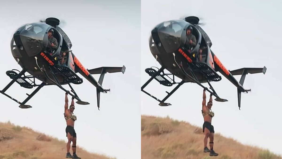 Ashton Hall risks it all to hang from a speeding helicopter in new extreme fitness stunt
