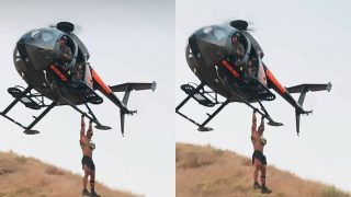 Ashton Hall risks it all to hang from a speeding helicopter in new extreme fitness stunt