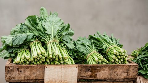 Fresh sukuma wiki displayed for sale at a market stall