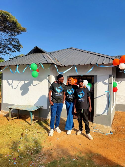 Nebs and Nyaythira with fan infront of new home