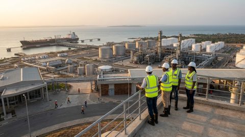 Overview of a refinery complex and port facility during early morning operations.
